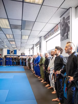 Atlas students lined up around the edges of BJJ gym