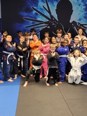 Children posing for photo in BJJ gym