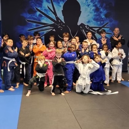 Children posing for photo in BJJ gym