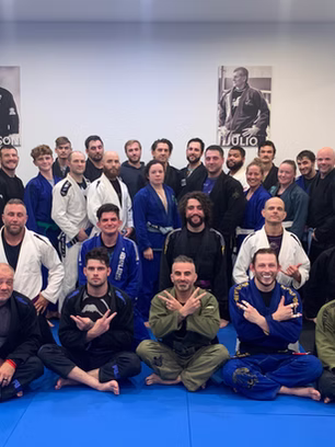 BJJ students and instructors posing for group photo in gym