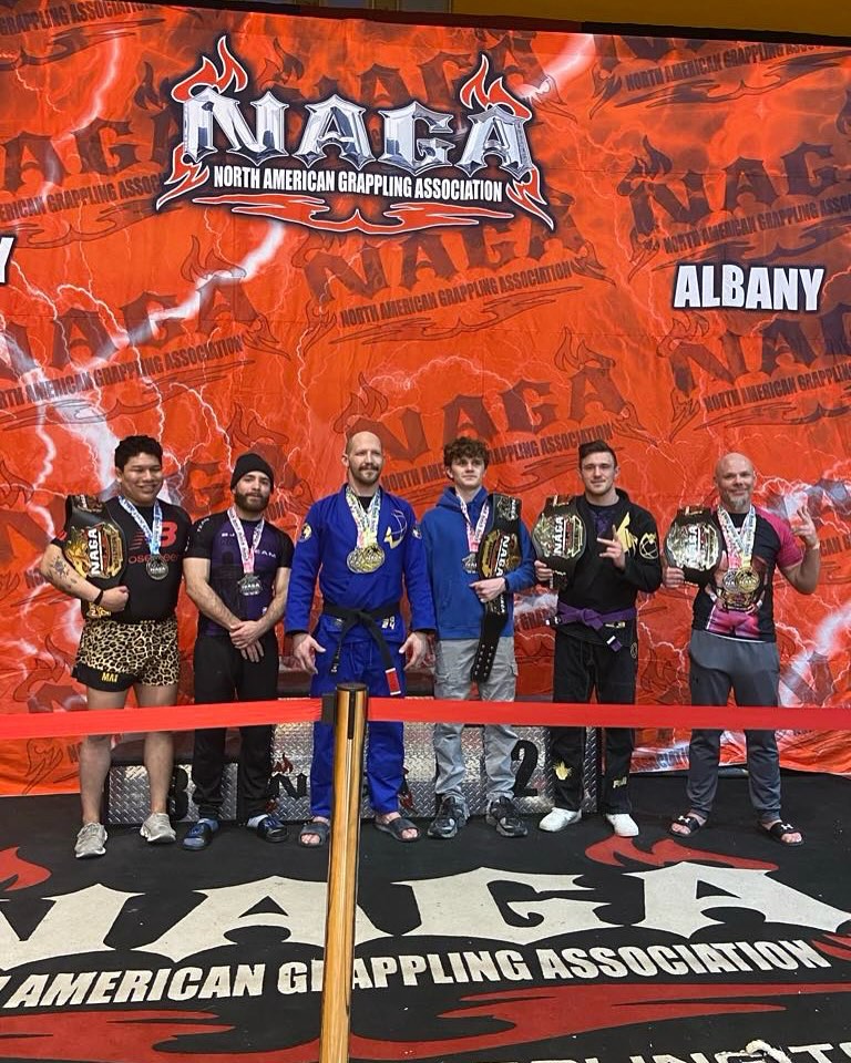 Wrestlers from Atlas Jiu Jitsu posing for photo at North American Grappling Association wrestling competition