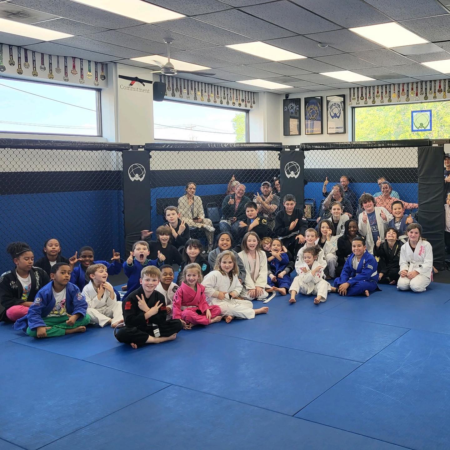 Tiny Titans class posing in the Atlas Jiu Jitsu gym